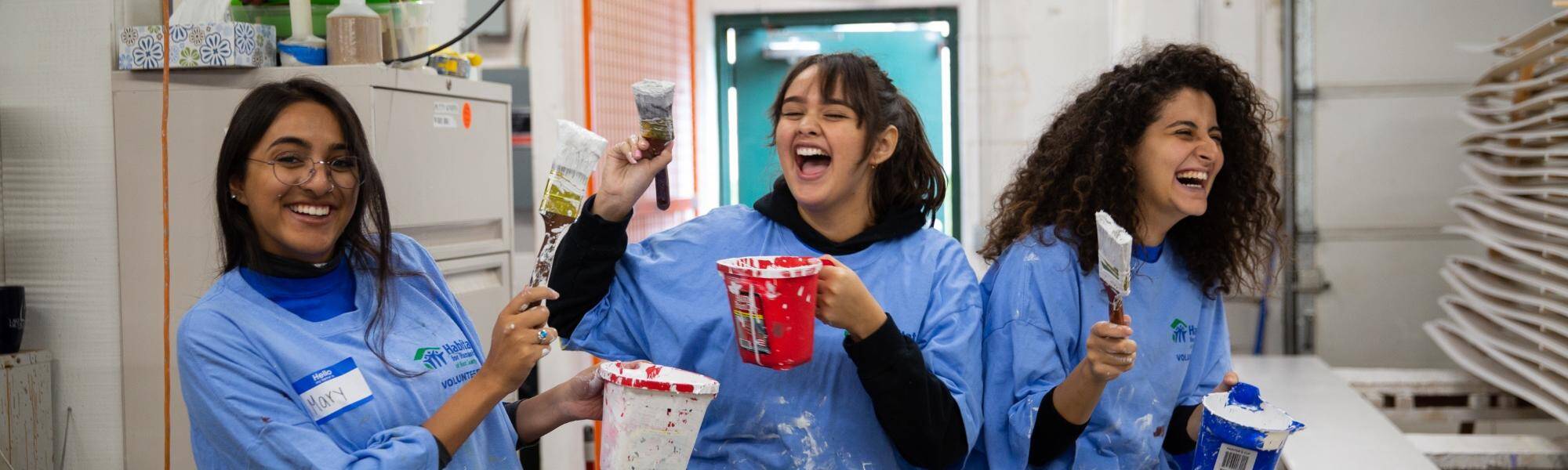Volunteers painting on Make A Difference Day